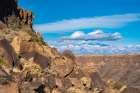 USA, New Mexico, Rio Grande del Norte National Monument. Rocky cliff and mountain landscape. Art Print